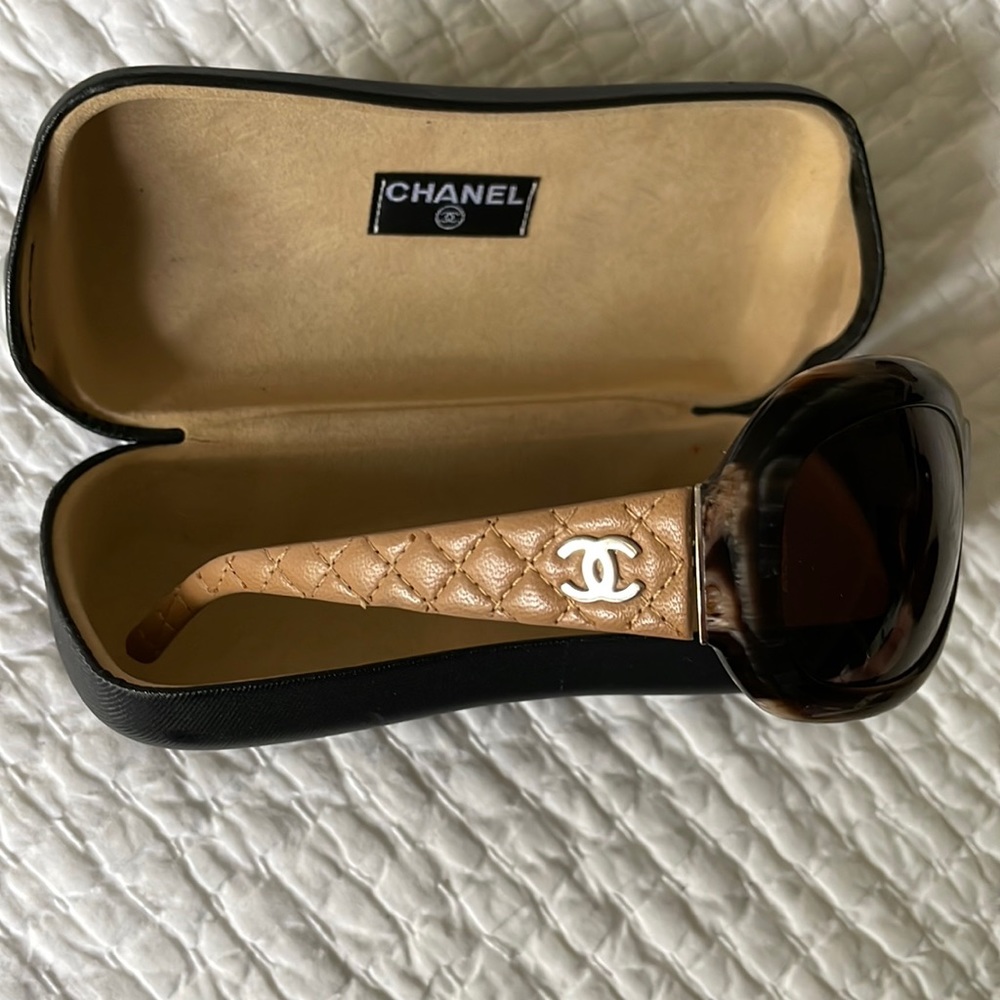 CHANEL.  And perfect.  No scratches.  Leather quilted temple arms with CC logo